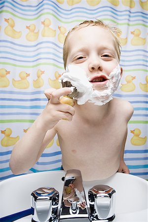 shaving kids boys - Boy shaving in bathroom and smiling Stock Photo - Premium Royalty-Free, Code: 640-02773641