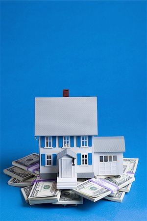 Toy house on pile of one hundred dollar bills Stock Photo - Premium Royalty-Free, Code: 640-02773693