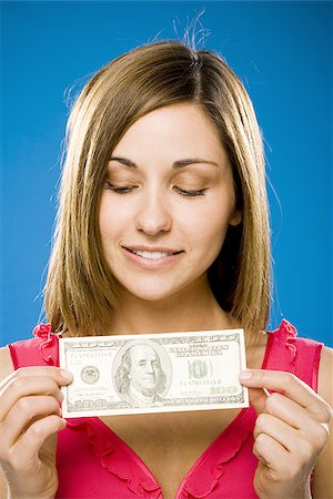 Woman holding American hundred dollar bill Stock Photo - Premium Royalty-Free, Code: 640-02773969