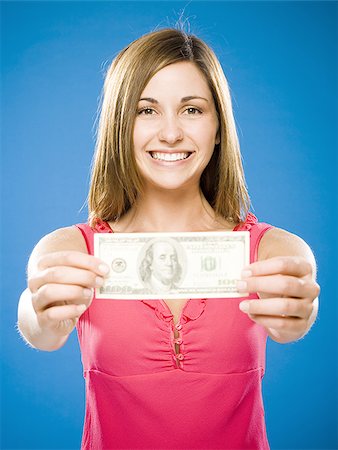 Woman holding American hundred dollar bill Stock Photo - Premium Royalty-Free, Code: 640-02773971