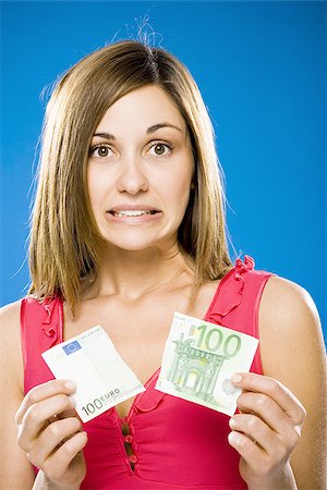 Woman with torn one hundred euro banknote Stock Photo - Premium Royalty-Free, Code: 640-02773984