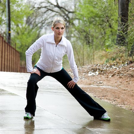 woman stretching before a workout Stock Photo - Premium Royalty-Free, Code: 640-02947546