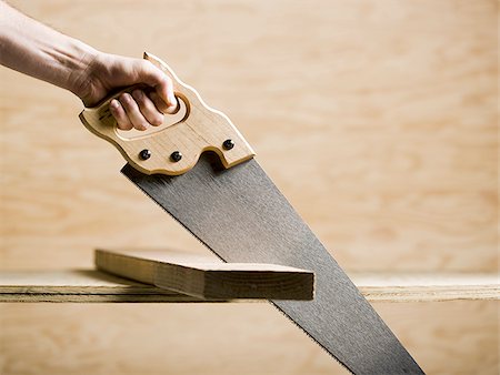 sawing - saw in a piece of wood Stock Photo - Premium Royalty-Free, Code: 640-02948045