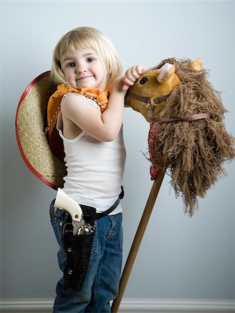 little girl dressing up as a cowgirl Stock Photo - Premium Royalty-Free, Code: 640-02949173