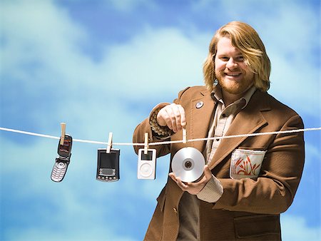 man hanging tech devices on a clothesline Stock Photo - Premium Royalty-Free, Code: 640-02949219