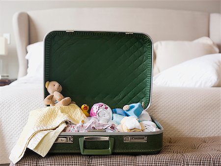 suitcase sitting open on a bed Stock Photo - Premium Royalty-Free, Code: 640-02949781
