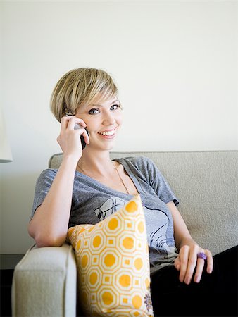 woman on the couch using cell phone Stock Photo - Premium Royalty-Free, Code: 640-02950166