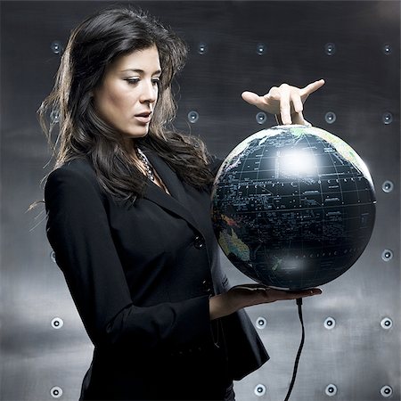 businesswoman with a globe in her hands Stock Photo - Premium Royalty-Free, Code: 640-02950839