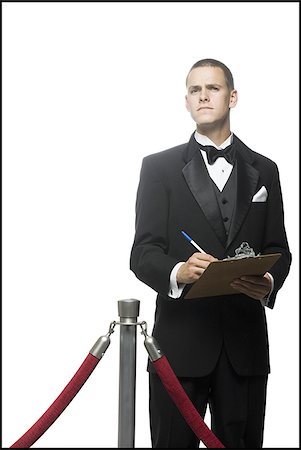 man in a tuxedo next to a velvet rope Stock Photo - Premium Royalty-Free, Code: 640-02951023