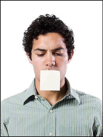 man with a post it note over his mouth Stock Photo - Premium Royalty-Free, Code: 640-02951531