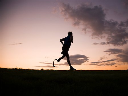 jogger with a right below knee prosthetic running leg Foto de stock - Sin royalties Premium, Código: 640-02952358