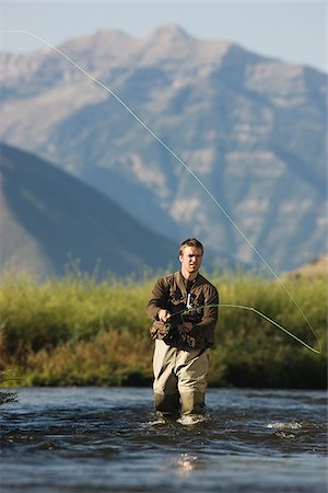 fly fisherman fishing in a mountain river Stock Photo - Premium Royalty-Free, Code: 640-02952374