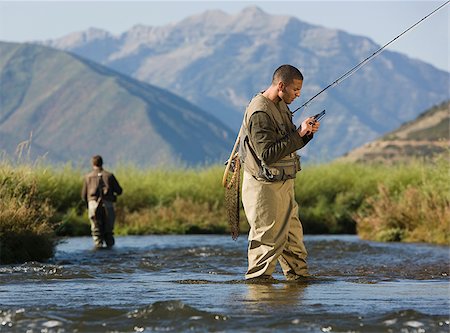 fly fisherman fishing in a mountain river Stock Photo - Premium Royalty-Free, Code: 640-02952377