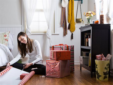 woman wrapping gifts in her bedroom Stock Photo - Premium Royalty-Free, Code: 640-02953092