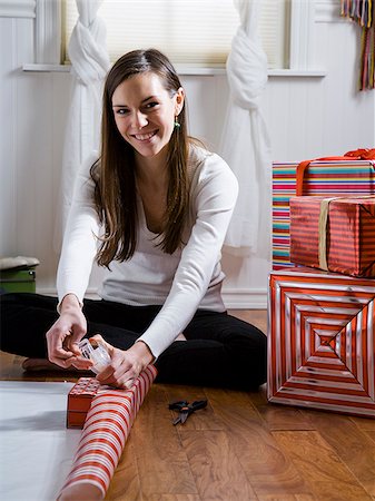 woman sitting on the floor wrapping presents Stock Photo - Premium Royalty-Free, Code: 640-02953260
