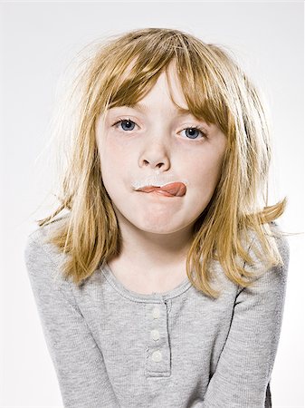 sticking out - girl looking at the camera sticking out her tongue Stock Photo - Premium Royalty-Free, Code: 640-02953285