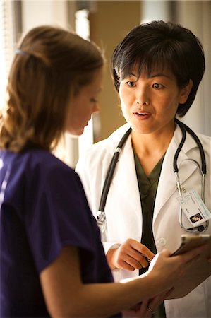 Female doctor talking to nurse Stock Photo - Premium Royalty-Free, Code: 640-03255811