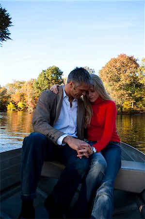 Couple sitting by water Stock Photo - Premium Royalty-Free, Code: 640-03255867