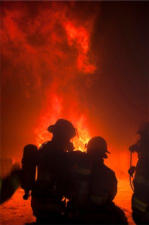 Firefighters at work rear view Stock Photo - Premium Royalty-Free, Code: 640-03255879