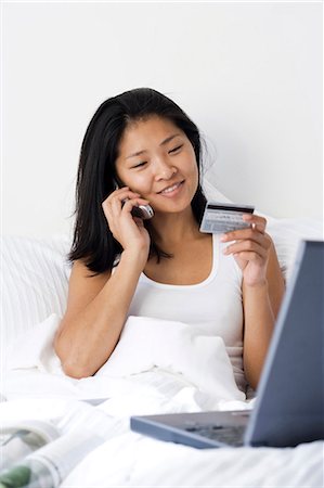 Woman working from bed Stock Photo - Premium Royalty-Free, Code: 640-03255904