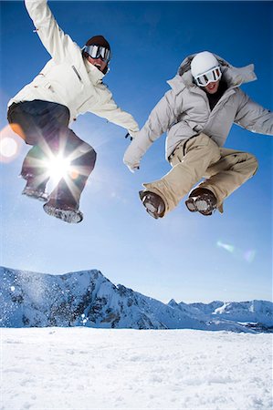 simsearch:640-03264331,k - Two friends jumping outside in the snow Stock Photo - Premium Royalty-Free, Code: 640-03256120