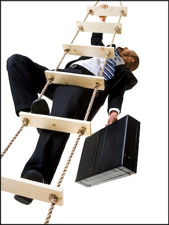 Businessman climbing a ladder with briefcase Stock Photo - Premium Royalty-Free, Code: 640-03256205