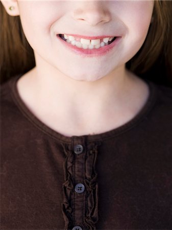 Close-up of girl (8-9) smiling Stock Photo - Premium Royalty-Free, Code: 640-03256758