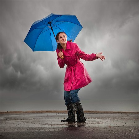 puddle in the rain - USA, Utah, Orem, woman with umbrella standing in puddle Stock Photo - Premium Royalty-Free, Code: 640-03256963
