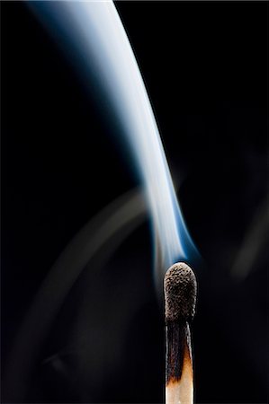 Smoking match against black background Stock Photo - Premium Royalty-Free, Code: 640-03257015