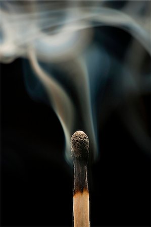 Smoking match against black background Stock Photo - Premium Royalty-Free, Code: 640-03257013