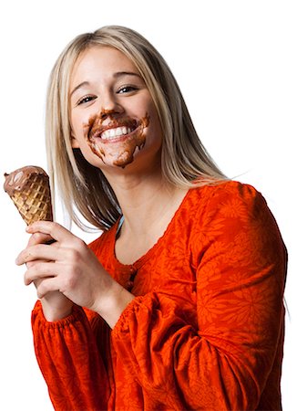 eating ice cream - Studio portrait of young woman with ice cream on face Stock Photo - Premium Royalty-Free, Code: 640-03257522