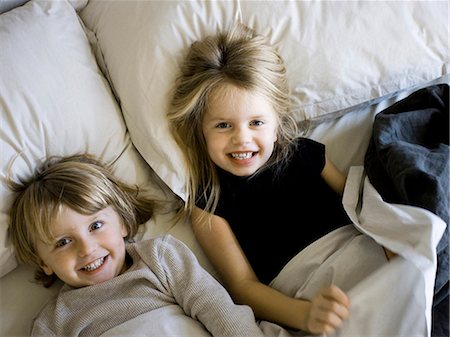 simsearch:640-06963757,k - USA, Utah, Provo, Portrait of brother and sister (2-5) lying in bed Stock Photo - Premium Royalty-Free, Code: 640-03257577