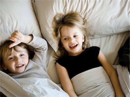 simsearch:640-06963757,k - USA, Utah, Provo, Portrait of brother and sister (2-5) lying in bed Stock Photo - Premium Royalty-Free, Code: 640-03257579