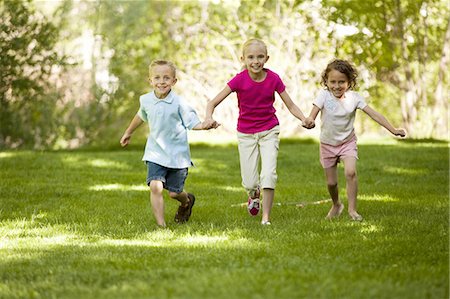 simsearch:640-03263432,k - Three children running in park Stock Photo - Premium Royalty-Free, Code: 640-03257931