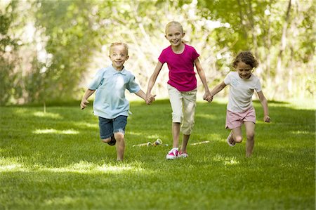 simsearch:640-03263432,k - Three children running in park Stock Photo - Premium Royalty-Free, Code: 640-03257932