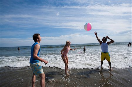 simsearch:640-03258693,k - Trois adultes jouant avec un ballon de plage Photographie de stock - Premium Libres de Droits, Code: 640-03258772