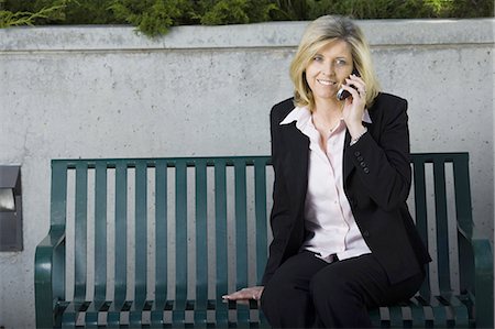 Femme d'affaires sur cellulaire assis sur un banc Photographie de stock - Premium Libres de Droits, Code: 640-03259482