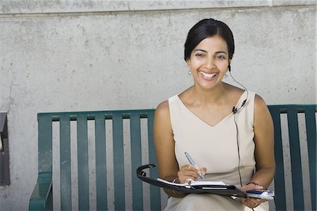 Woman working sitting on bench Stock Photo - Premium Royalty-Free, Code: 640-03259505