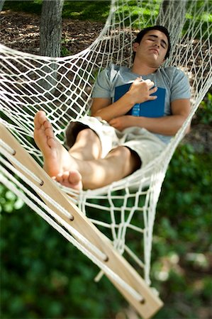 sleep book - Man who fell asleep reading in a hammock Stock Photo - Premium Royalty-Free, Code: 640-03259812