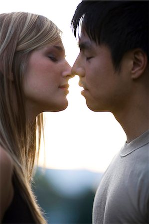 romantic boy and girl - Young couple about to kiss Stock Photo - Premium Royalty-Free, Code: 640-03259853
