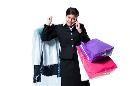 simsearch:640-03260747,k - Woman with shopping bags talking on cellphone Stock Photo - Premium Royalty-Free, Code: 640-03264698