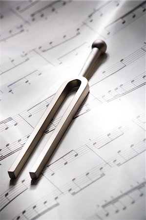 Tuning fork resting on musical score Stock Photo - Premium Royalty-Free, Code: 640-03265044