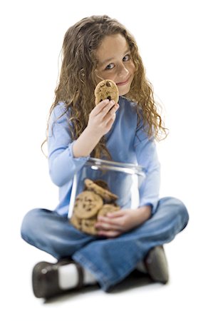 Young girl taking cookie from cookie jar Foto de stock - Sin royalties Premium, Código: 640-03265230