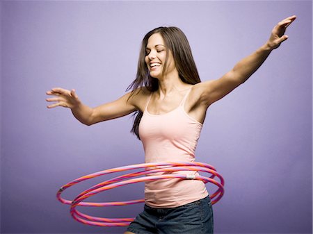 simsearch:640-03265333,k - Woman dancing and playing with hula hoops Stock Photo - Premium Royalty-Free, Code: 640-03265341