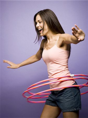 simsearch:640-03265333,k - Woman dancing and playing with hula hoops Stock Photo - Premium Royalty-Free, Code: 640-03265342