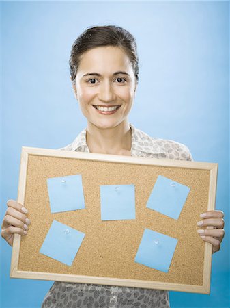 self adhesive note - Close-up of a young woman holding a bulletin board Stock Photo - Premium Royalty-Free, Code: 640-03265377