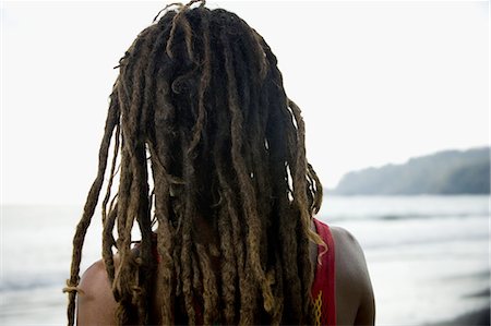 dreadlocks on african americans - Rear view of a young man on the beach Stock Photo - Premium Royalty-Free, Code: 640-03265750
