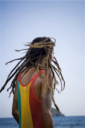 dreadlocks on african americans - Rear view of a young man on the beach Stock Photo - Premium Royalty-Free, Code: 640-03265751