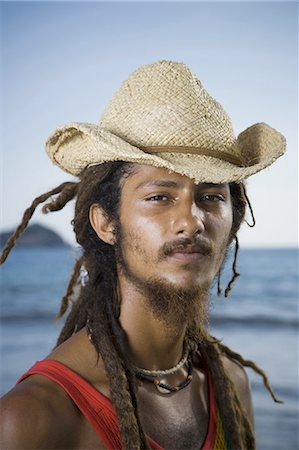 dreadlocks on african americans - Portrait of a young man wearing a straw hat Stock Photo - Premium Royalty-Free, Code: 640-03265762