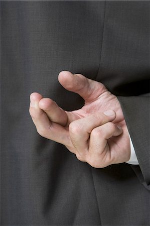 Fingers crossed behind businessman's back Stock Photo - Premium Royalty-Free, Code: 640-03260039